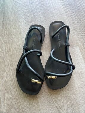 Emme Parsons “Laurie Sandals” Black Ankle-Strap Sandals with Gold Accent